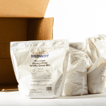 Photo of an unpacked case of Midway Premium Gluten-Free Waffle Cone Mix on a white background